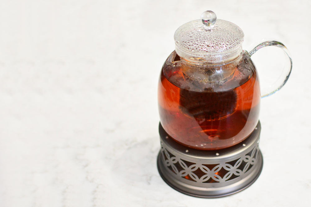 Grosche-Munich-on-Sahara-teapot-warmer-with-red-tea-on-marble-counter-side-1000