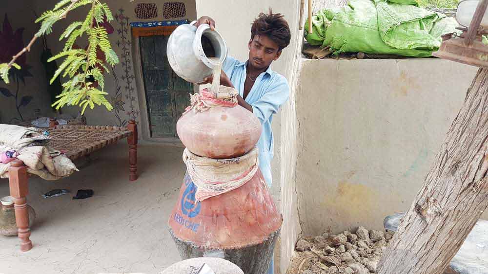 pouring dirty water into a biosand water filter