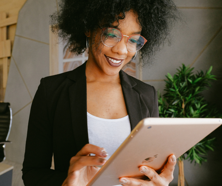 Image of a woman smiling holding an ipad