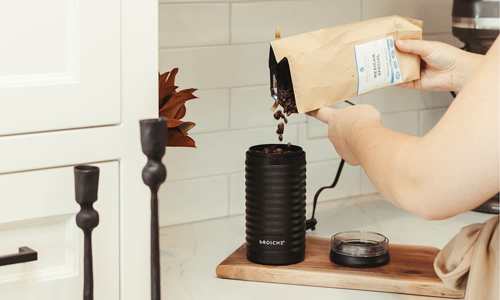 GROSCHE Arabica Coffee Beans ground up being poured into Electric Coffee Grinder