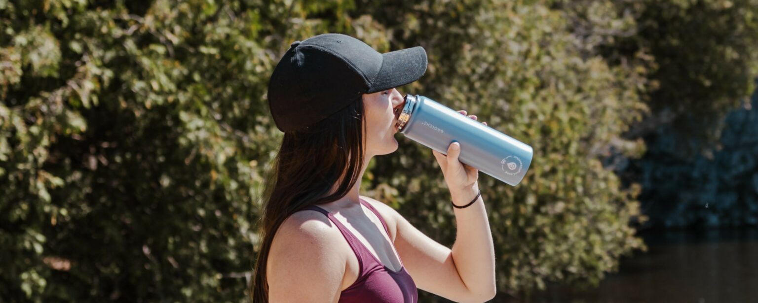 Girl sipping from Chicago Steel Blue Stainless Steel Wide Mouth Water Bottle