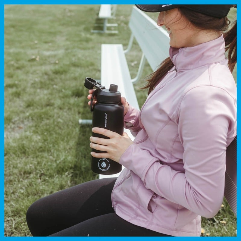 Drinking from Chicago Steel Charcoal Black water bottle on a bench